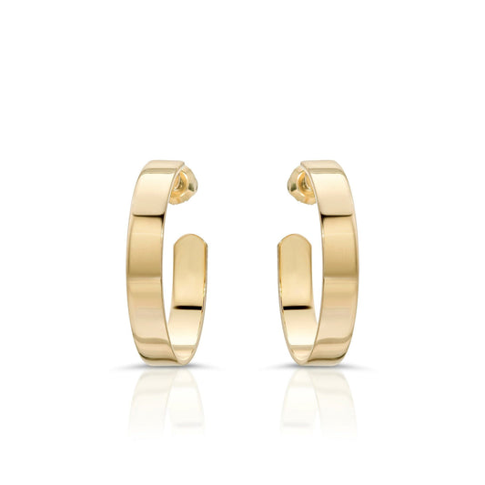 Shiny gold 1 inch Isla Hoops earrings showing off a cute and trendy style